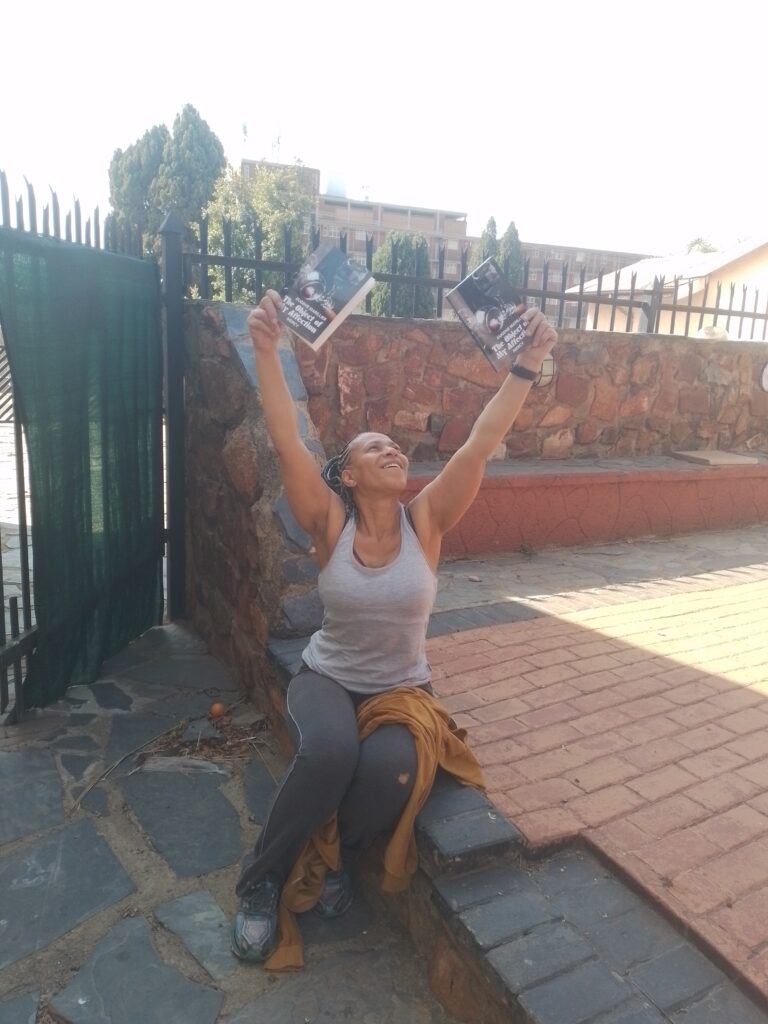 Eugene Marillier holding her second book – symbol of transformation and divine purpose